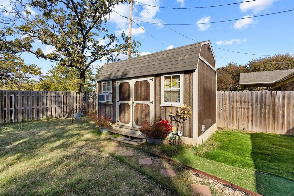 1417 Morrison Drive Denison, TX 75020 - Photo 29 of 30 View of shed with a fenced backyard