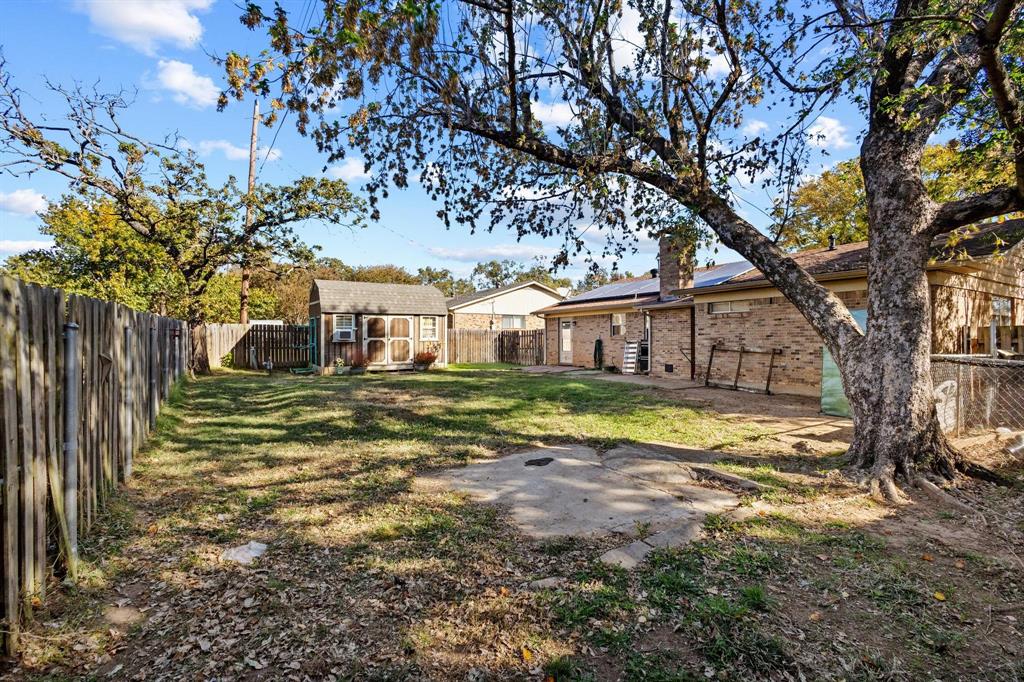 1417 Morrison Drive Denison, TX 75020 - Photo 30 of 30 Fenced backyard featuring a patio and a shed