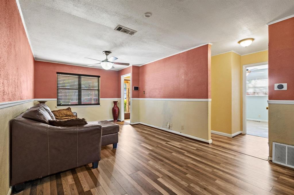 1417 Morrison Drive Denison, TX 75020 - Photo 7 of 30 Living room with ceiling fan, wood-type flooring, and a textured ceiling