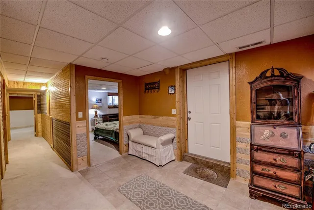 a view of a hallway with couch and a dresser