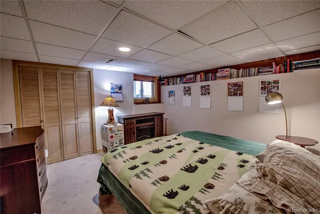 a bedroom with a bed dresser and a flat screen tv