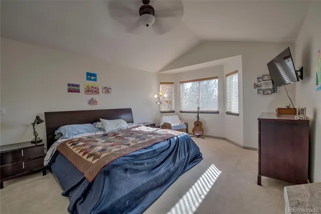 a bedroom with a bed and large window