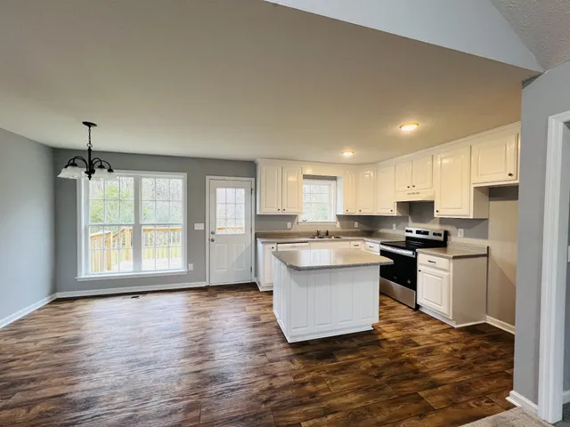 a kitchen with a sink stove and cabinets