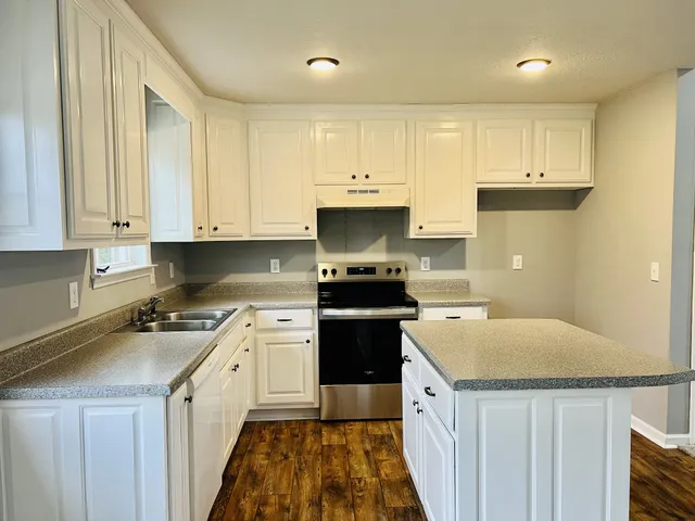 a kitchen with a sink stove and refrigerator