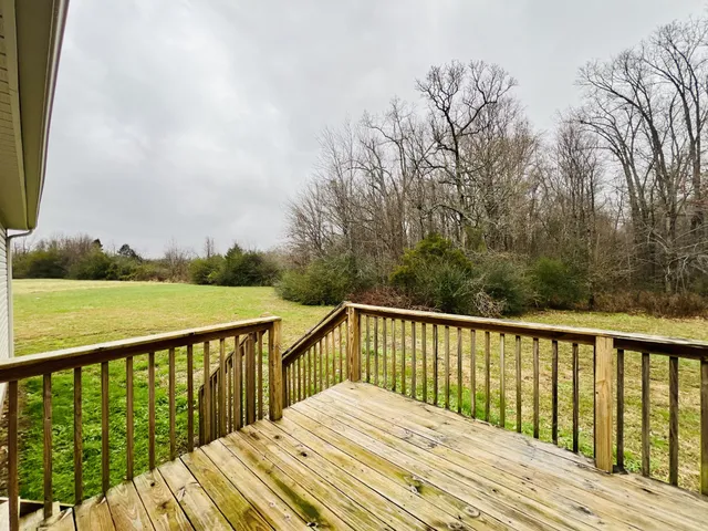a balcony view with wooden floor and fence