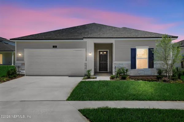 a front view of a house with a yard and garage