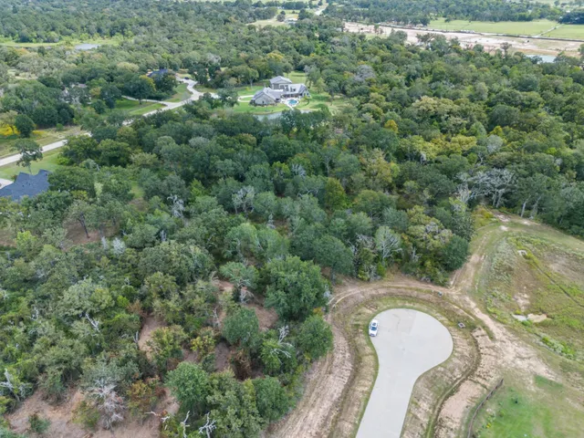 an aerial view of a house with yard and outdoor seating