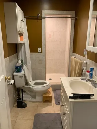 a bathroom with a sink toilet and shower