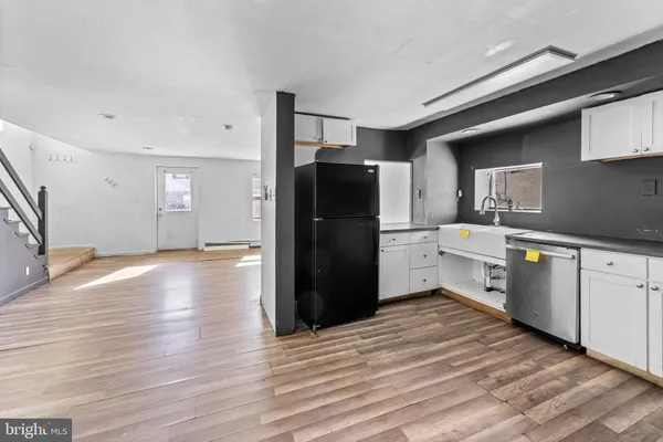 a kitchen with a refrigerator and a sink