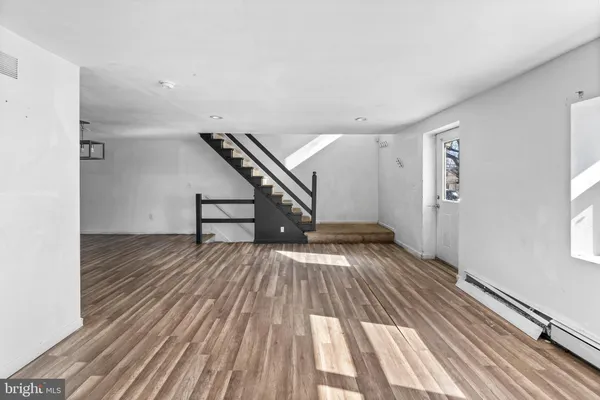 a view of an entryway with wooden floor