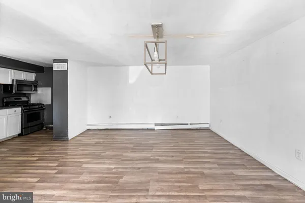 a view of a room with wooden floor