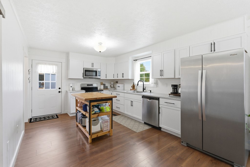 114 Viars Road Philadelphia, TN 37846 - Photo 13 of 45 a kitchen with wooden floors and white appliances