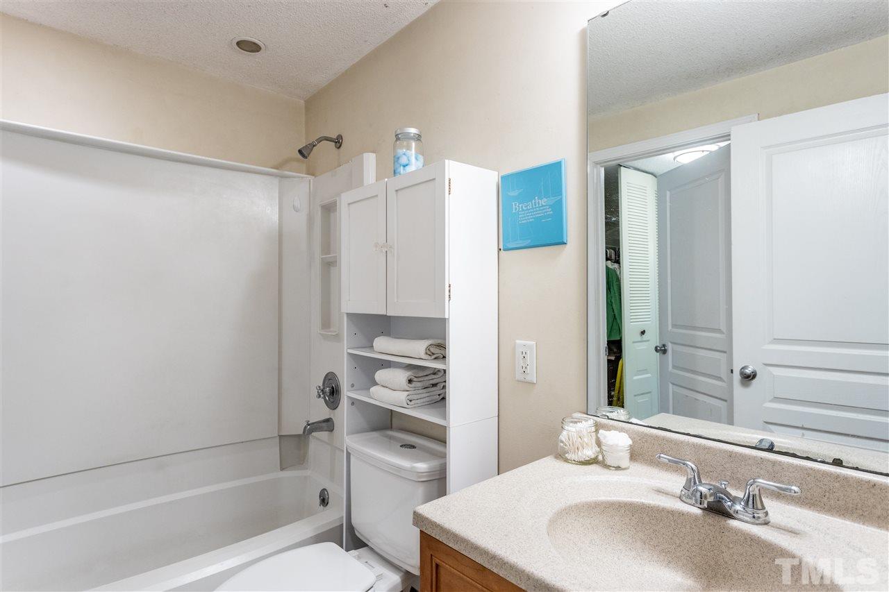 7720 Sandra Lane Raleigh, NC 27615 - Photo 14 of 25 a bathroom with a sink toilet and shower