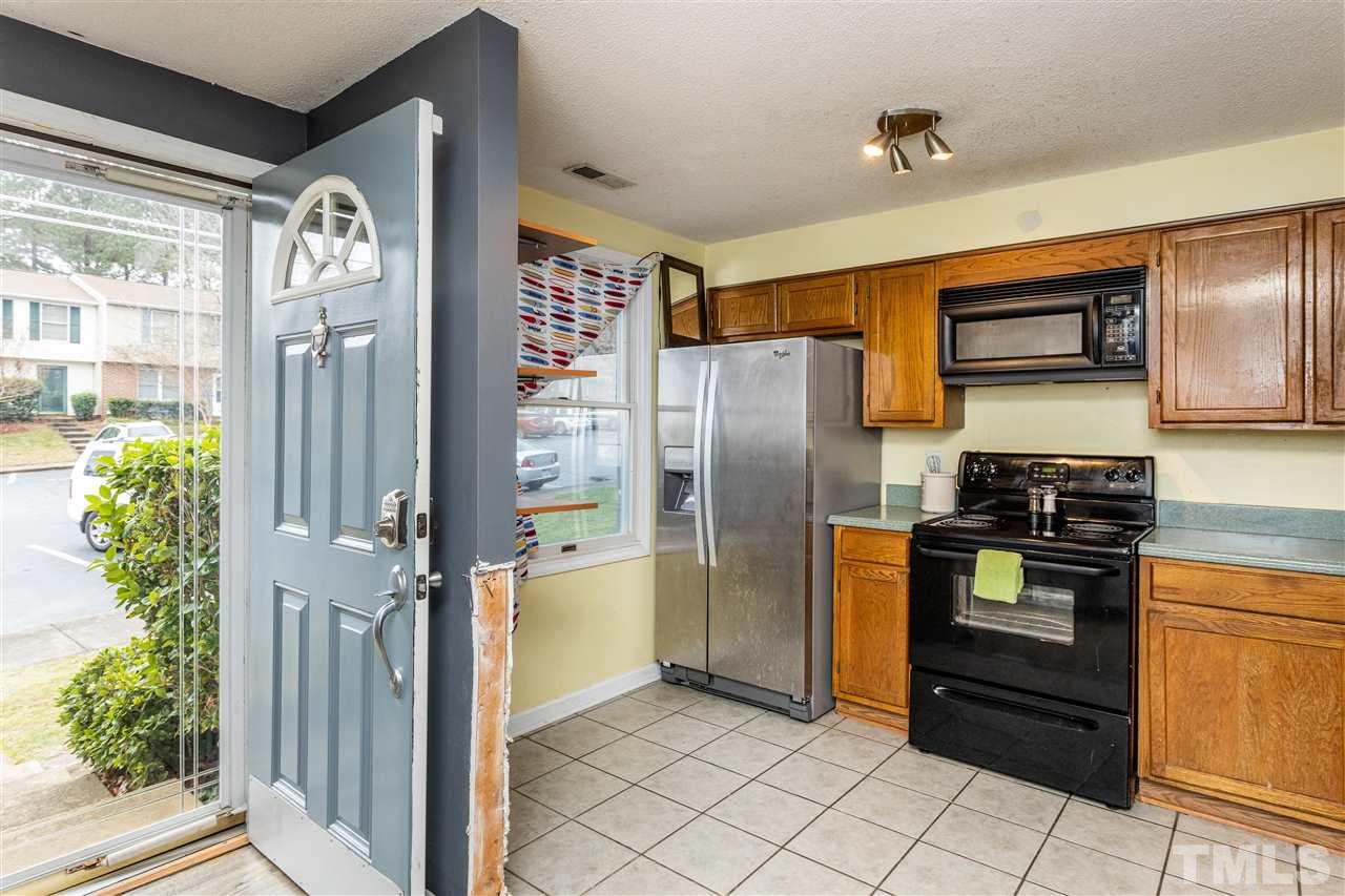 7720 Sandra Lane Raleigh, NC 27615 - Photo 3 of 25 a kitchen with stainless steel appliances granite countertop a refrigerator and a stove