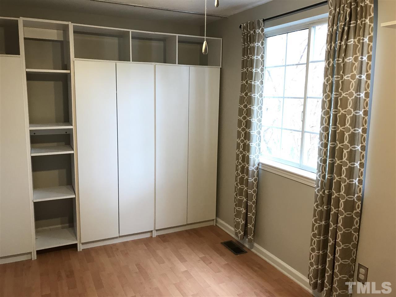 7720 Sandra Lane Raleigh, NC 27615 - Photo 21 of 25 a view of an empty room with wooden floor and a window