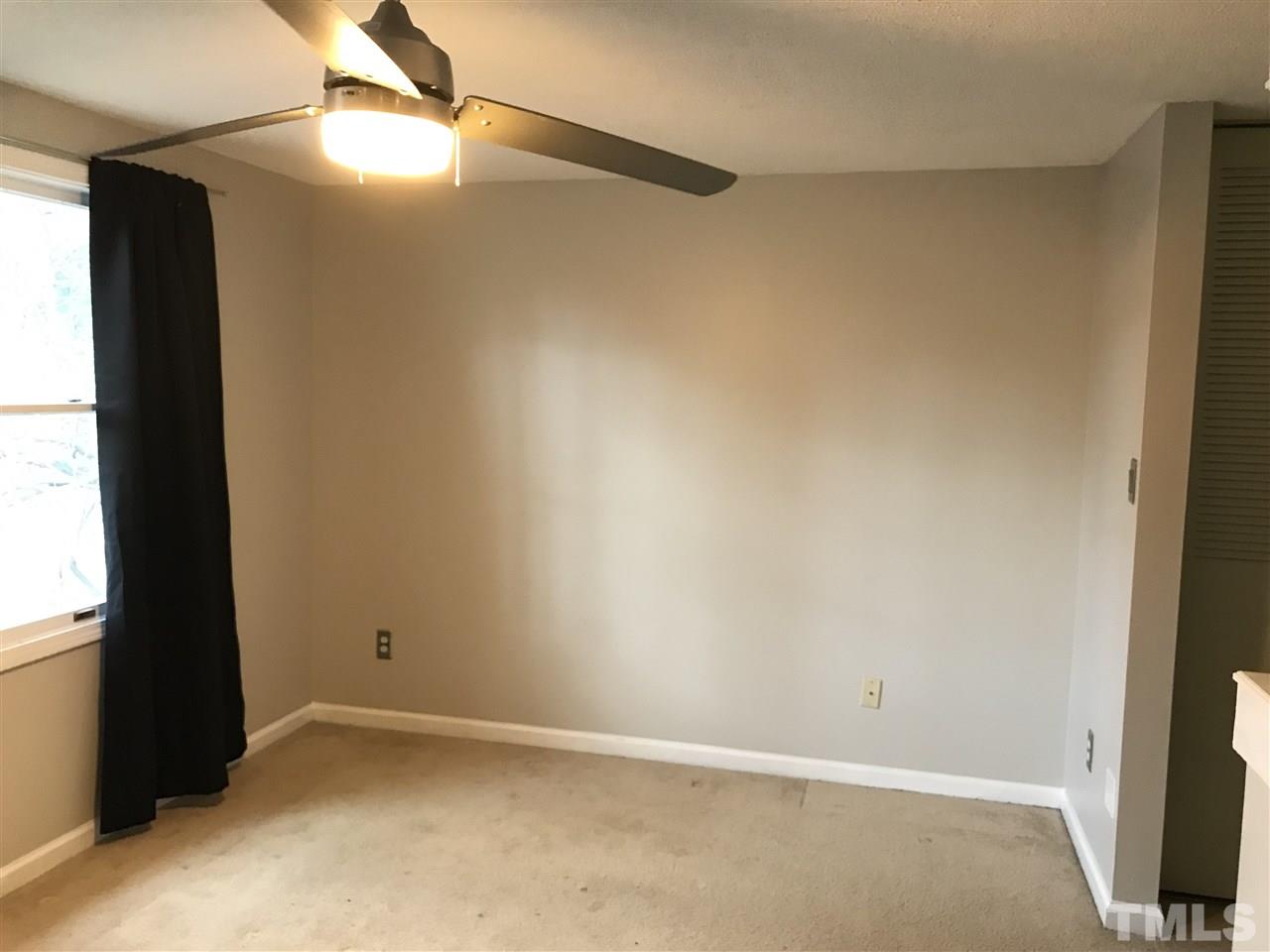7720 Sandra Lane Raleigh, NC 27615 - Photo 22 of 25 an empty room with a window and a fan