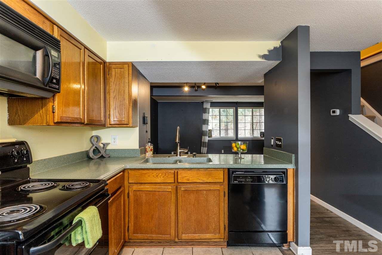 7720 Sandra Lane Raleigh, NC 27615 - Photo 6 of 25 a kitchen with a stove and a sink