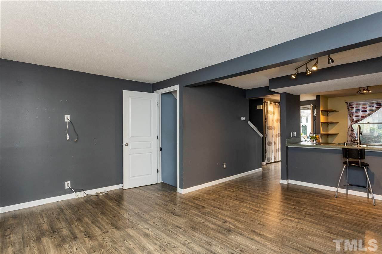 7720 Sandra Lane Raleigh, NC 27615 - Photo 8 of 25 a view of empty room with wooden floor and furniture