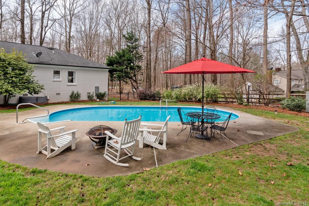 2800 High Ridge Road Charlotte, NC 28270 - Photo 28 of 34 a view of a backyard with table and chairs under an umbrella