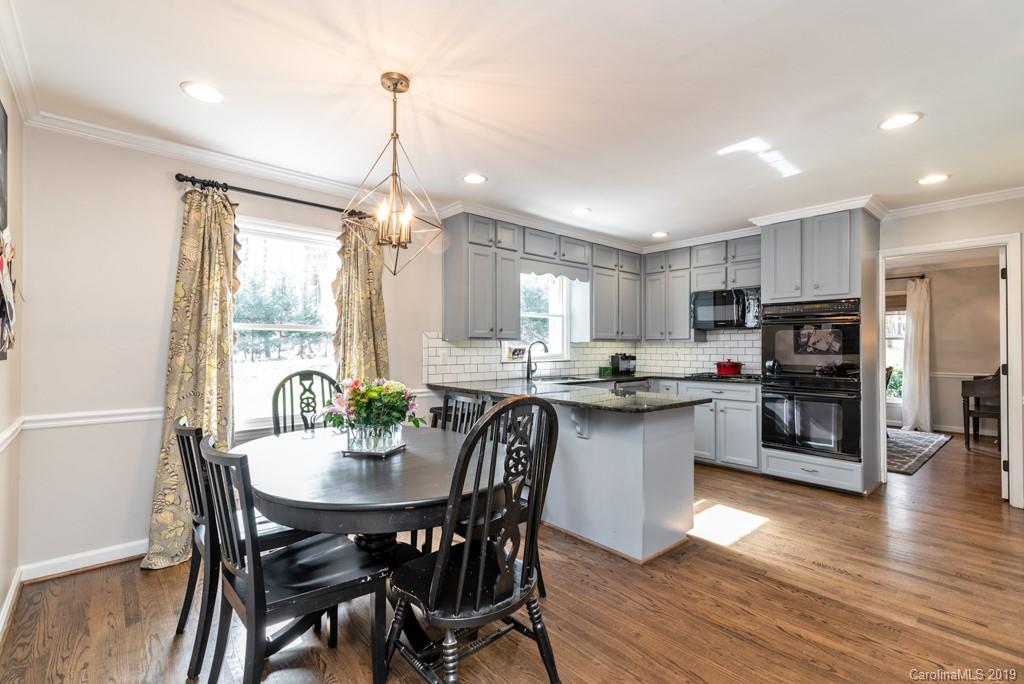 2800 High Ridge Road Charlotte, NC 28270 - Photo 10 of 34 a kitchen with stainless steel appliances granite countertop a dining table chairs stove refrigerator and cabinets