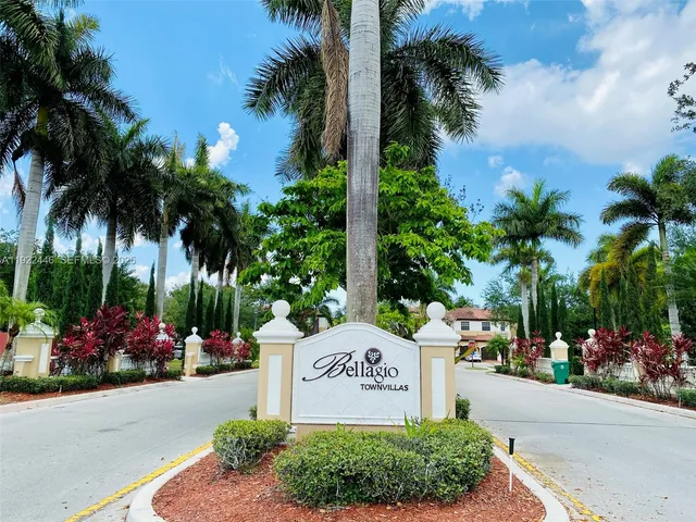 a sign that is sitting in front of flowers