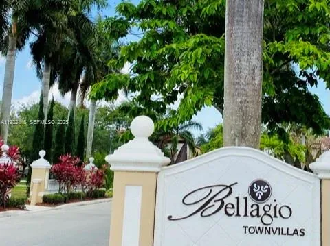 a view of sign board with flower plants