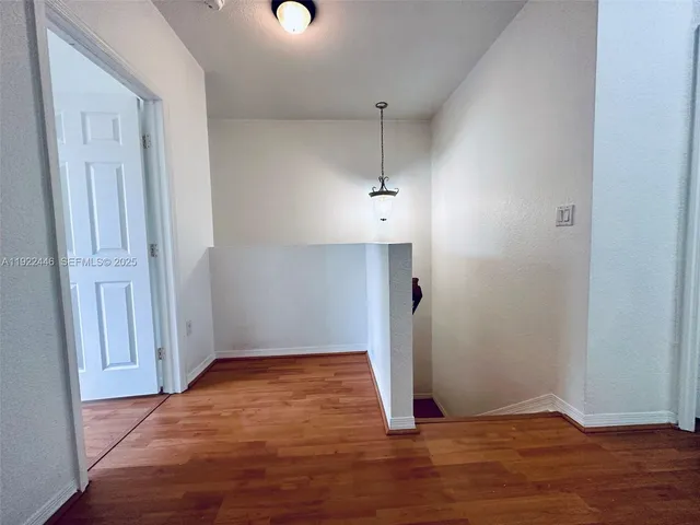 an empty room with wooden floor