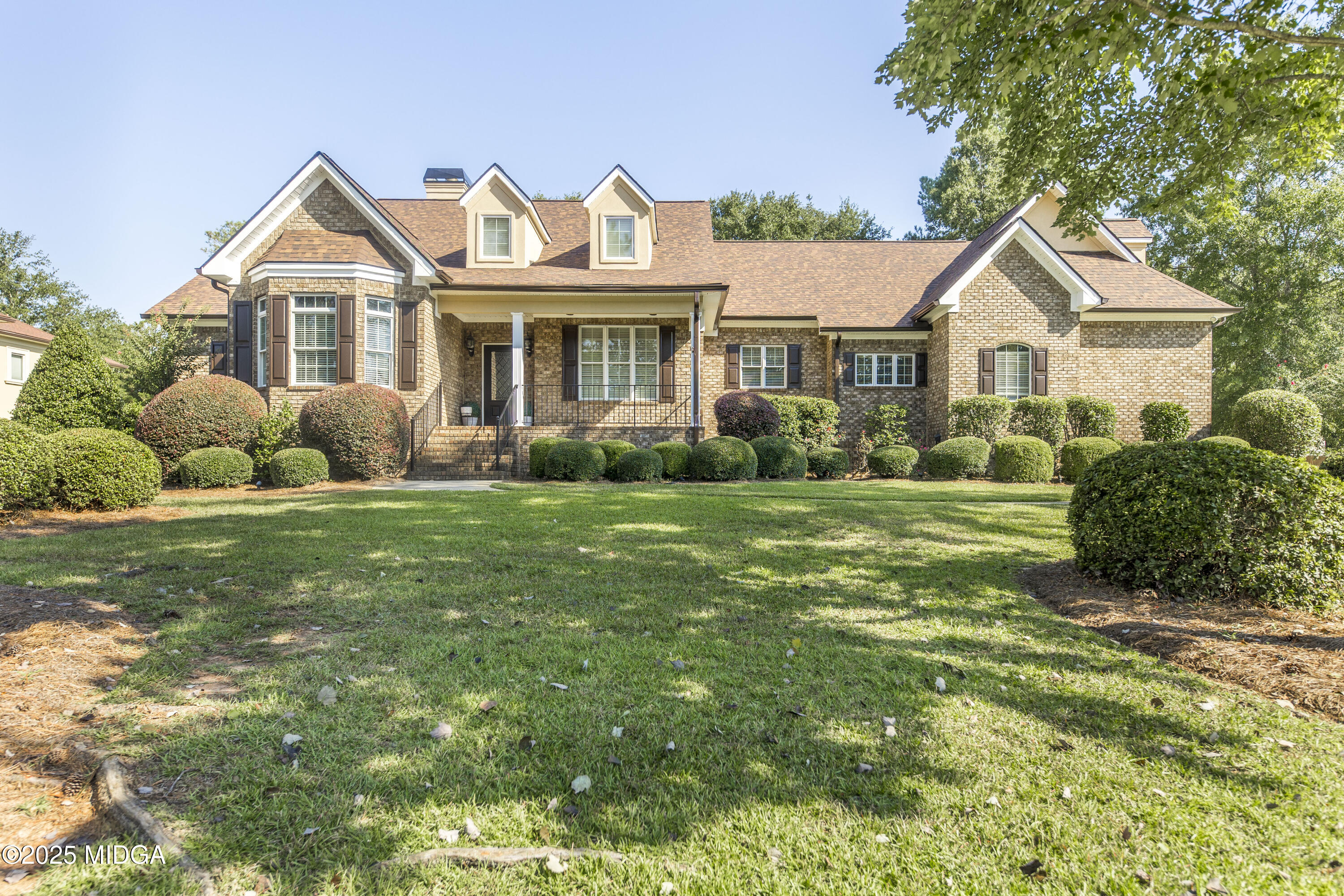 711 Latrobe Way Macon, GA 31220 - Photo 4 of 44 a front view of a house with a yard and garage