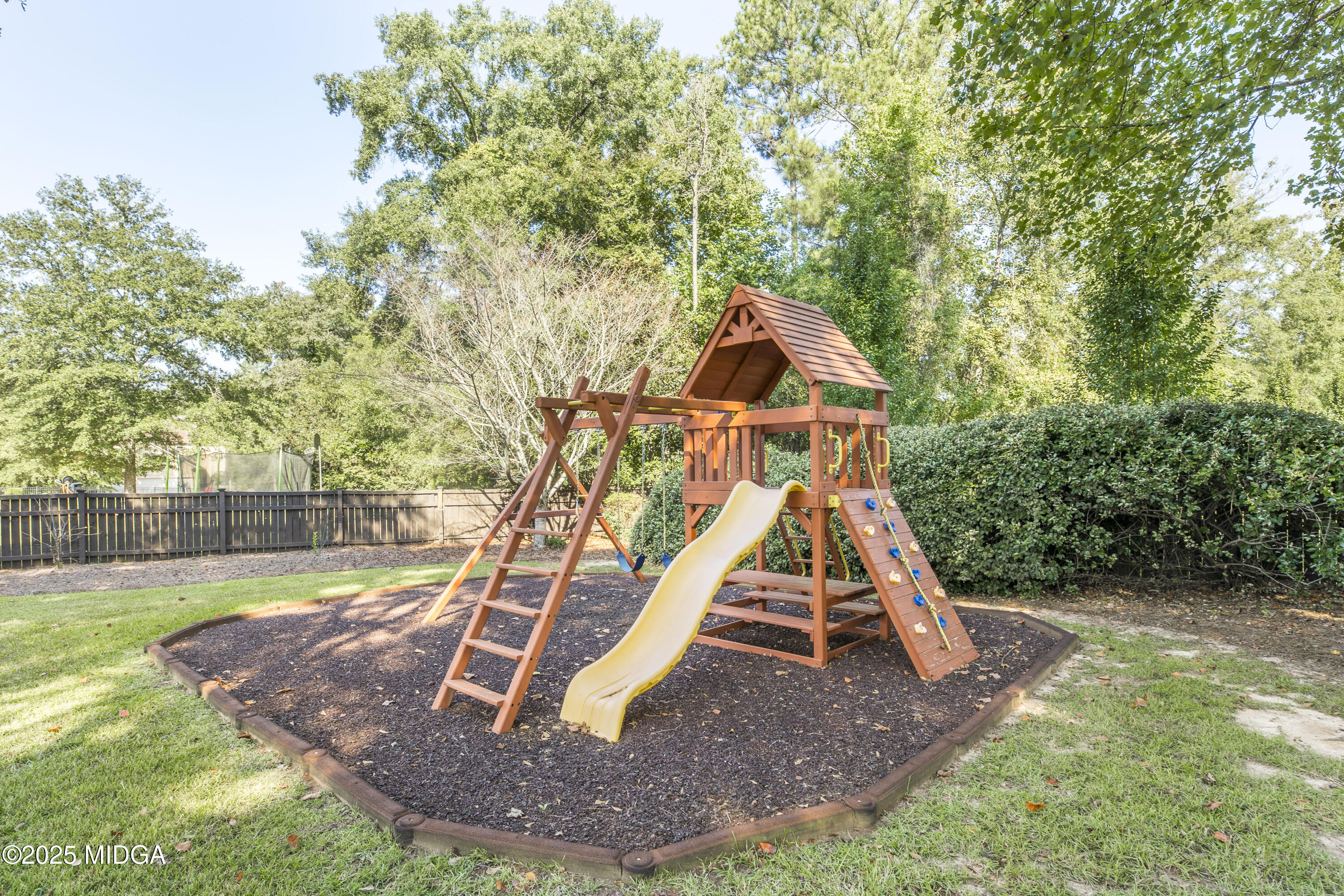 711 Latrobe Way Macon, GA 31220 - Photo 43 of 44 a view of a backyard with swings