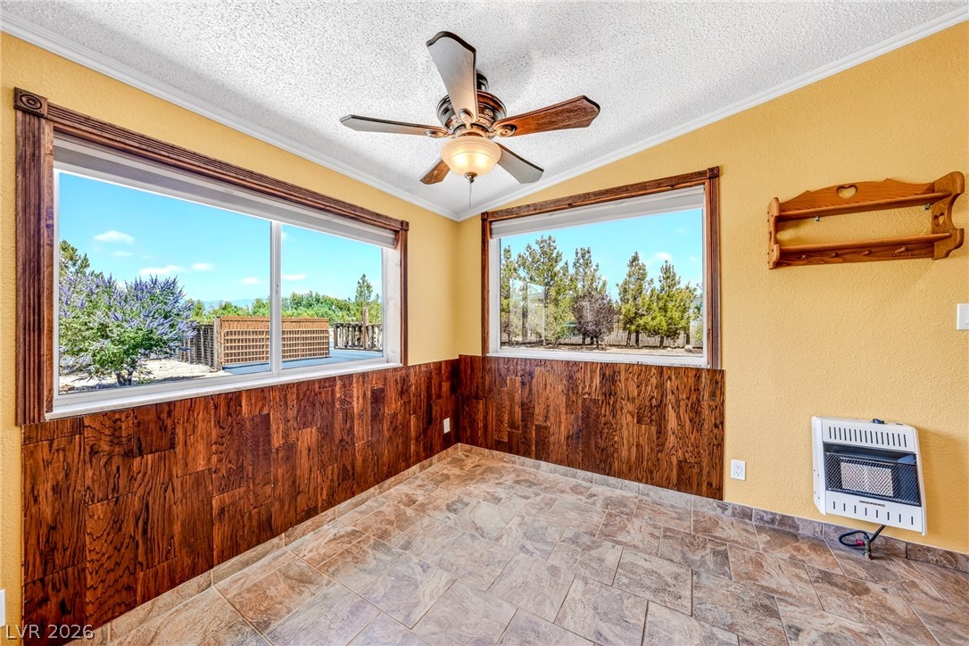 1831 West Horn Road Pahrump, NV 89048 - Photo 7 of 59 A versatile room provides scenic views and a ceiling fan for comfort.