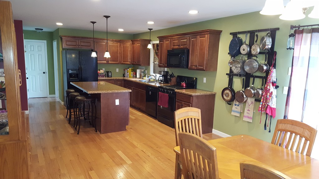 4 Mary Street Springfield, MA 01118 - Photo 6 of 16 a kitchen with stainless steel appliances granite countertop a refrigerator a stove top oven a sink and dishwasher