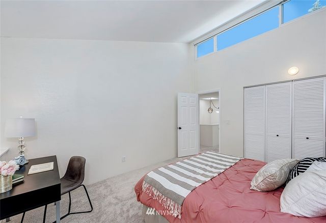 a bedroom with a bed and a potted plant