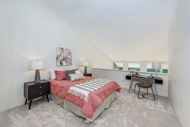 a bedroom with a bed and a chair