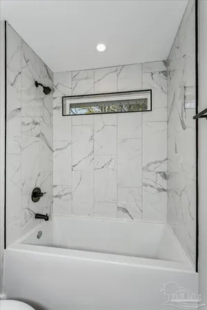 a bathroom with a shower and a bathtub