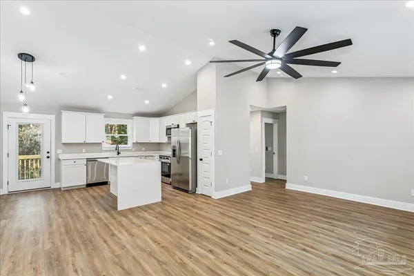 a view of a kitchen with wooden floor