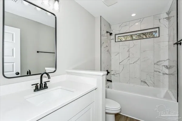 a bathroom with a sink a toilet and a bathtub