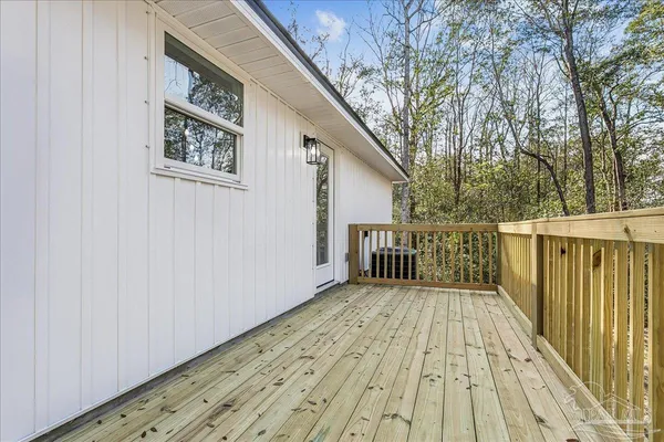 a view of backyard with deck and wooden floor