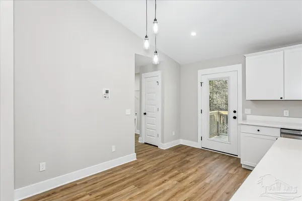 a view of a kitchen with wooden floor