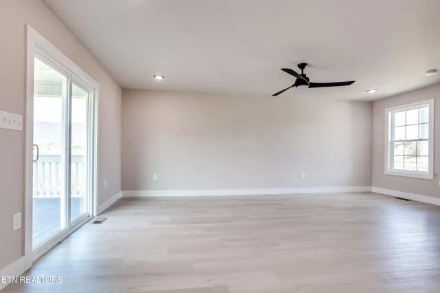 a view of room with hardwood floor and window