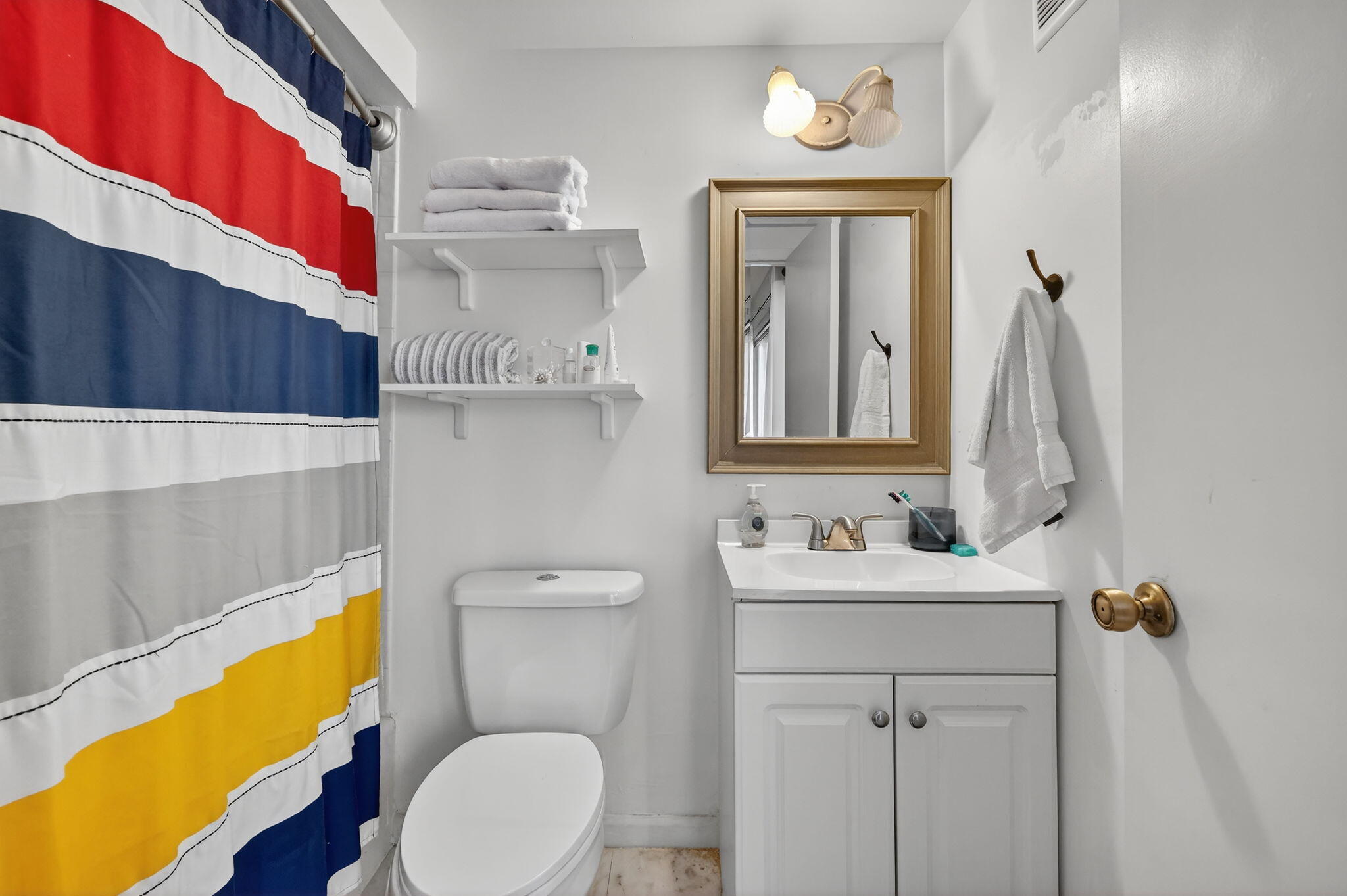 3860 Jefferson Street Stuart, FL 34997 - Photo 11 of 26 a bathroom with a sink a toilet and mirror