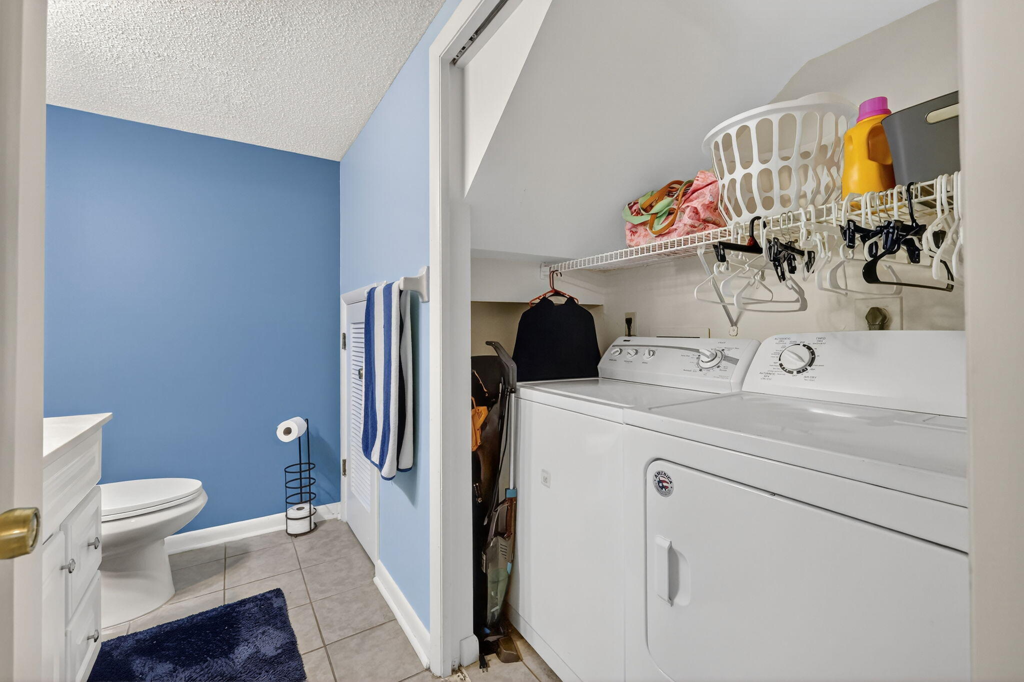3860 Jefferson Street Stuart, FL 34997 - Photo 13 of 26 a bathroom with a sink a toilet and a mirror