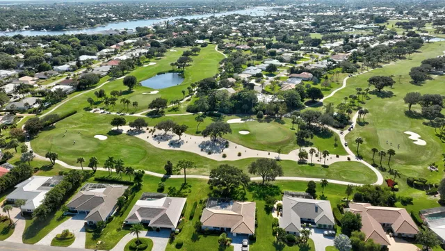an aerial view of residential houses with outdoor space and parking