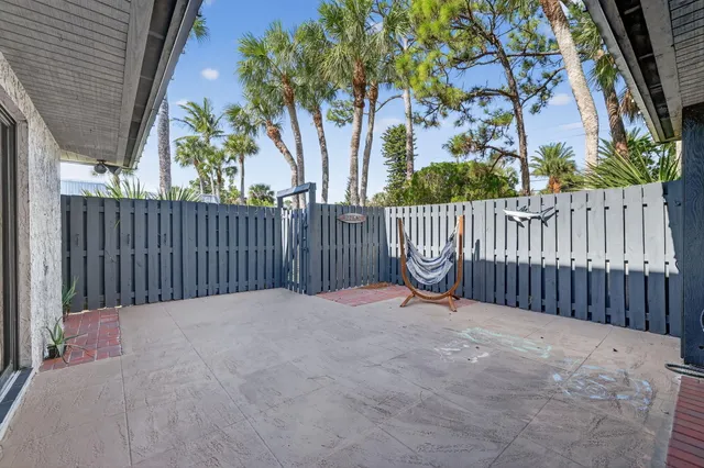 a view of a house with a wooden fence