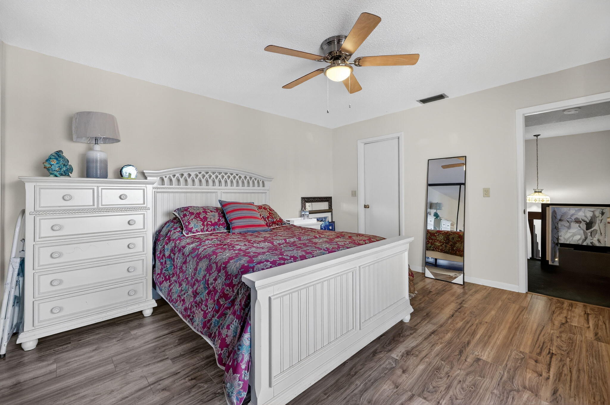 3860 Jefferson Street Stuart, FL 34997 - Photo 8 of 26 a bedroom with a bed and a chandelier