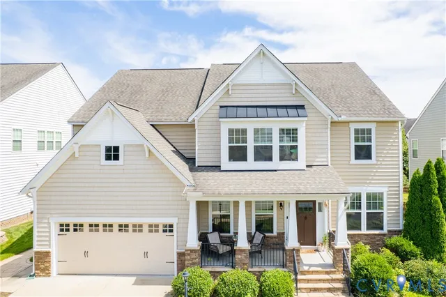a view of a house with garden and patio