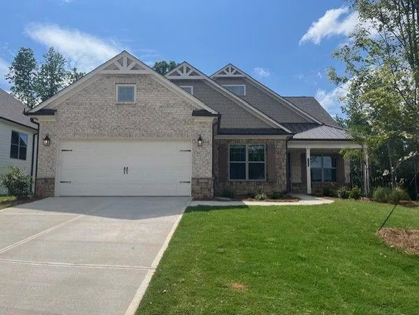a front view of a house with a yard and porch