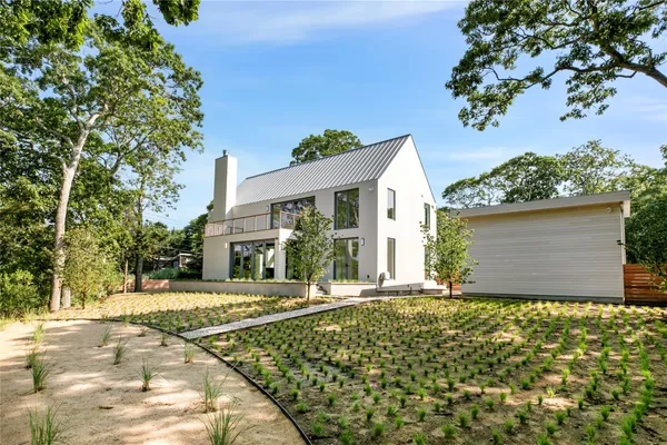 a view of a small house with a yard