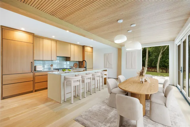 a kitchen with a white cabinets and chairs