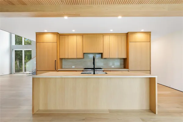 a view of a kitchen with a sink and window