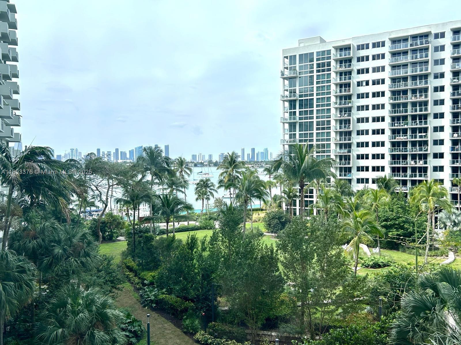 1500 Bay Road, Unit 558S Miami Beach, FL 33139 - Photo 15 of 18 a view of building with a yard and plants